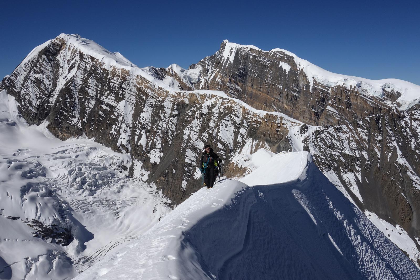a man on the chulu far east summit ridge
